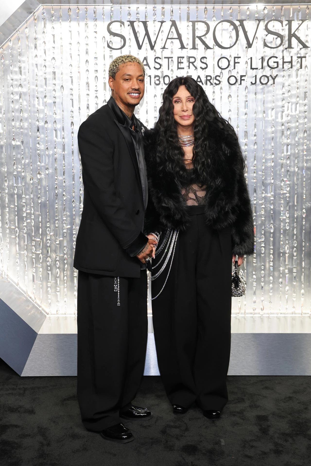 Александр Эдвардс и Шер | Getty Images